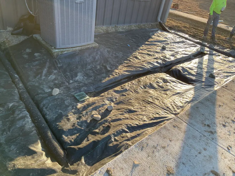 Landscape fabric laid along a house before a bed is filled